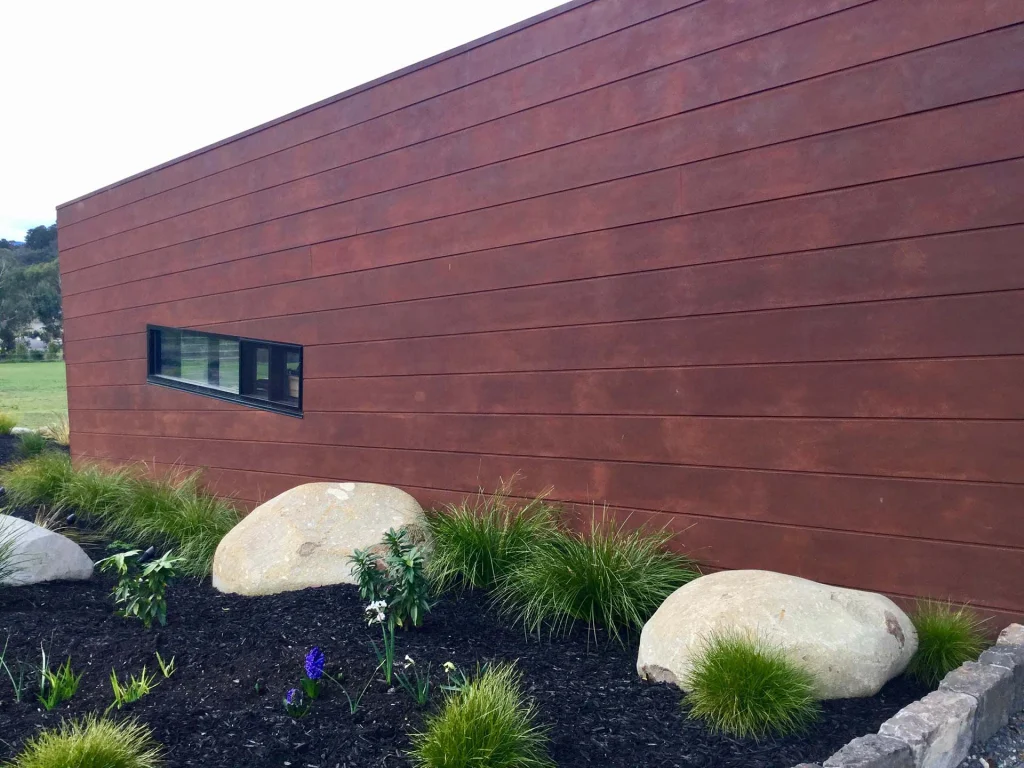 Commercial frontage with red feature cladding and landscaping