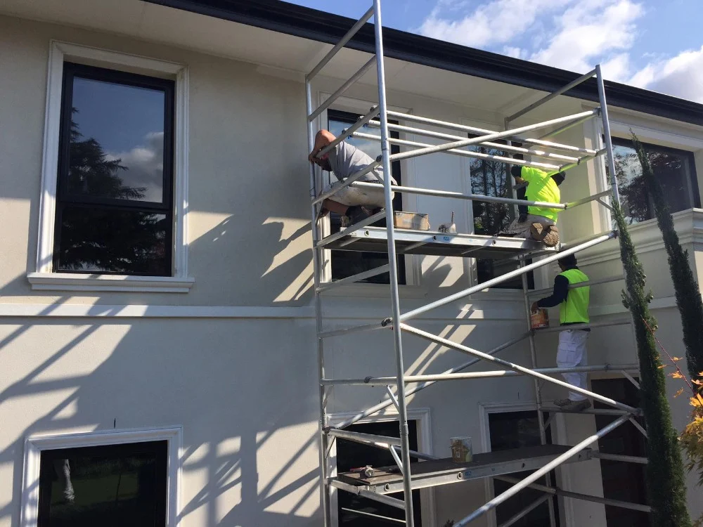 Eastend Painting crew on scaffolding repainting a two-storey rendered home