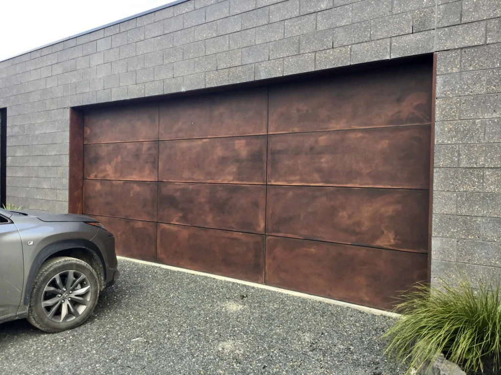 Rust-finish garage door set into grey blockwork
